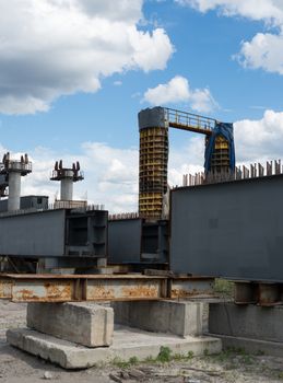 Bridge construction site with concrete piers already finished and still in the metal formwork.