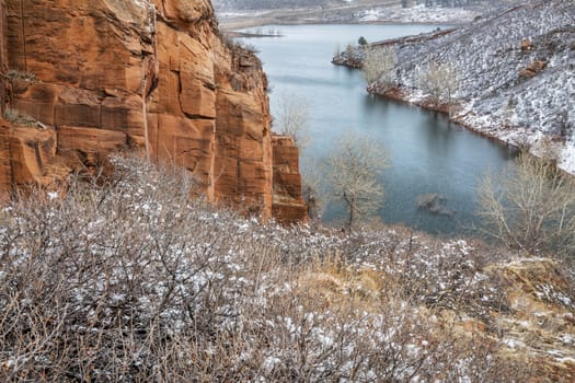 Old sandstone quarry on the shore of Horesetooth Reservoir near Fort Collins, Colorado, winter scenery with snow falling