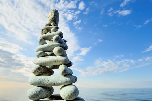 Pile of pebbles in the balance on the seacoast