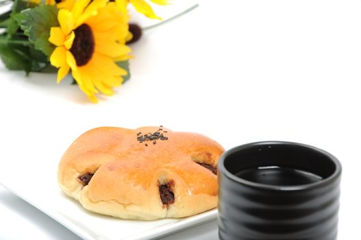 Red bean bread with green tea with flower background