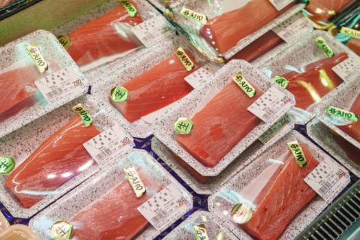 Osaka, Japan - Oct 26: Sashimi for sale in a seafood store in the Kuromon Market in Osaka, Japan on Oct 26, 2014. Sashimi is a Japanese food, which is raw meat or fish sliced into thin pieces.