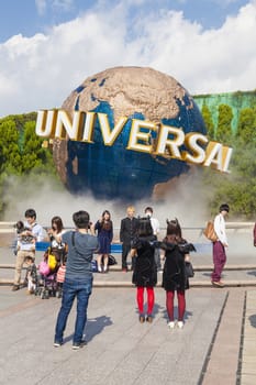 Osaka, Japan - Oct 27: View of tourists and Universal Globe outside the Universal Studios Theme Park in Osaka, Japan on Oct 27, 2014.  The theme park has many attractions based on the film industry.