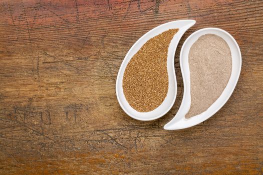 gluten free teff grain and flour in teardrop shaped bowls against grunge wood