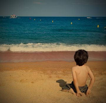 boy on the beach watching at the sea, instagram filter style