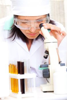 scientist looking into microscope at the lab