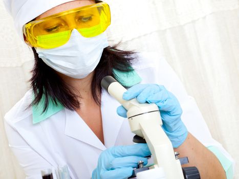 female scientist microscoping in the life science research laboratory (genetics, biochemistry, forensics, microbiology)