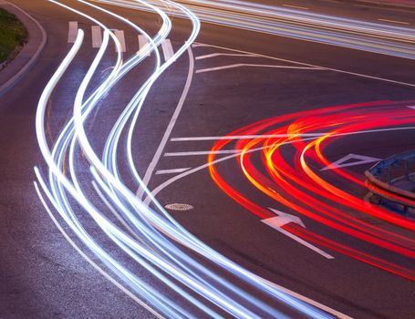 evening crossroad with varicolored lines of lights of cars. abstraction