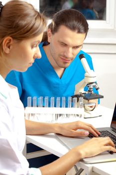 two scientists conduct scientific research in a lab