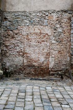 Bricked up doorway in a stone wall