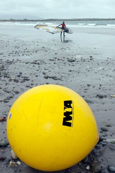 giant Irish windsurfing association yellow buoy on a beach in the wild atlantic way