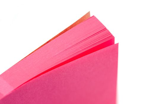 pink paper memo pad closeup with narrow d.o.f