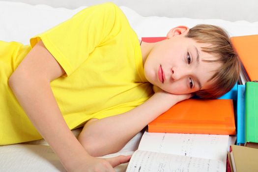 Sad and Tired Kid with the Books on the Bed