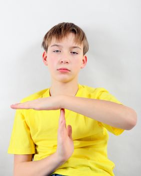 Tired Kid shows Time out gesture on the White Background