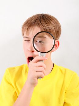 Teenager with Magnifying Lens on the White Background