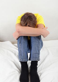 Sad Teenager on the Bed at the Home