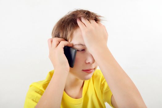 Sad Teenager with Cellphone on the White Background