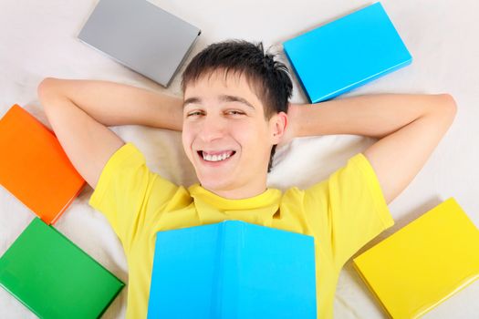 Happy Teenager with a Books on the Bed