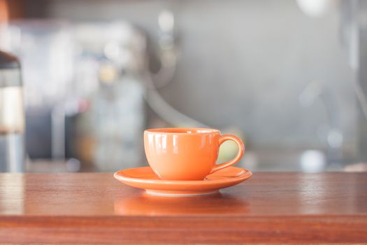 Mini orange coffee cup in coffee shop, stock photo