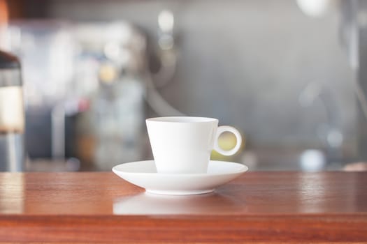 Mini white coffee cup in coffee shop, stock photo