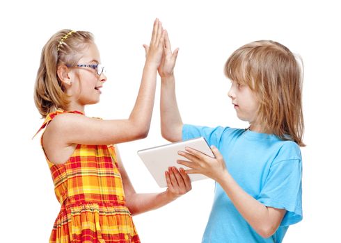 Two Children Doing High Five Gesture after Winning a Game on Tablet