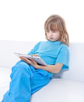 Boy with Long Blond Hair Playing with Digital Tablet - Isolated on White