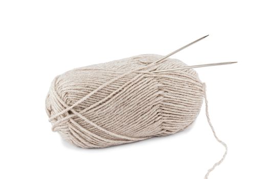 Beige wool yarn ball and spoke isolated on a white background