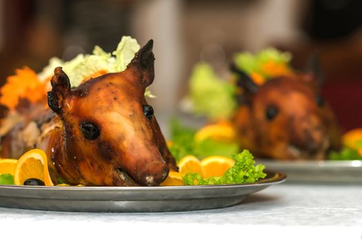 Roasted pig on a plate in a restaurant 