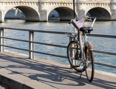 PARIS, FRANCE - CIRCA AUGUST 2009: A Velib' next to the river Seine. Velib' is a public bicycle sharing scheme