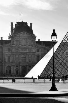 PARIS, FRANCE - CIRCA APRIL 2010: The Louvre Museum and the Pyramid which is the entrance for the museum. Black and white photography.