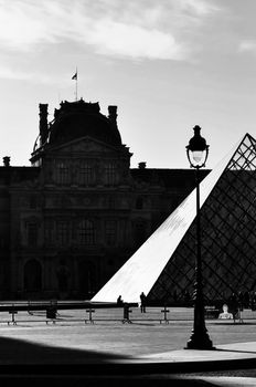 PARIS, FRANCE - CIRCA APRIL 2010: The Louvre Museum and the Pyramid which is the entrance for the museum. Black and white photography.