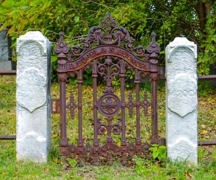 Rusty gate with white columns