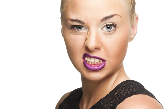 Close up Pretty Young Woman in Violet Lips Showing Wacky Face While Looking at the Camera. Isolated on White.