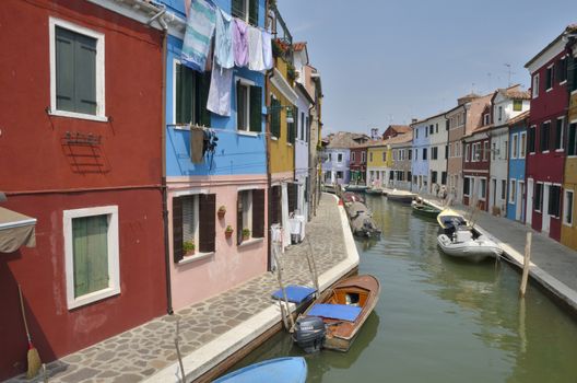 Color houses along a canal  in Burano, a colorful island of Venice, Italy