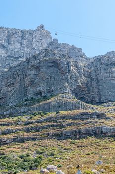 View of Table Mountain and upper cable station in Cape Town. A cable car is visible. The cableway was opened on October 4, 1929
