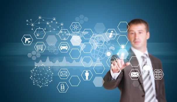 Businessman in suit finger presses virtual button. Hexagons with icons and glow circle as backdrop