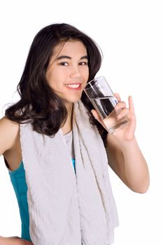 Beautiful biracial teenage girl drinking water while exercising