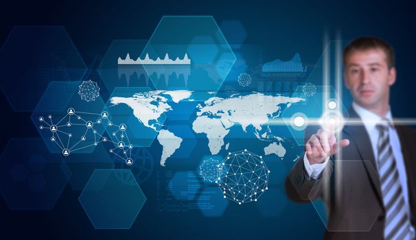 Businessman in suit finger presses virtual button. Hexagons, world map and glow circles as backdrop