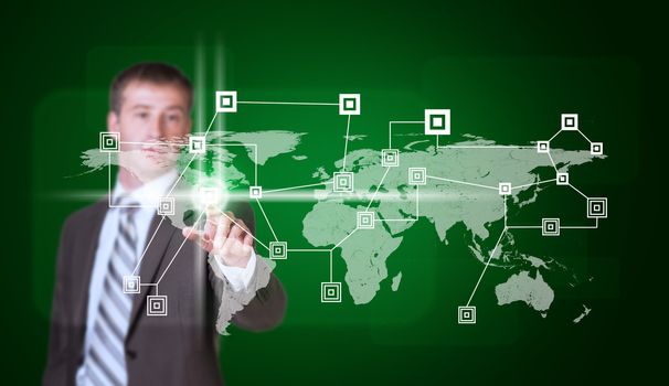 Businessman in suit finger presses virtual button. World map and network