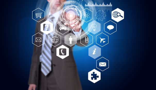 Businessman in suit finger presses virtual button. Hexagons with icons and glow circles