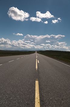 Picture of a empty long road with blue sky