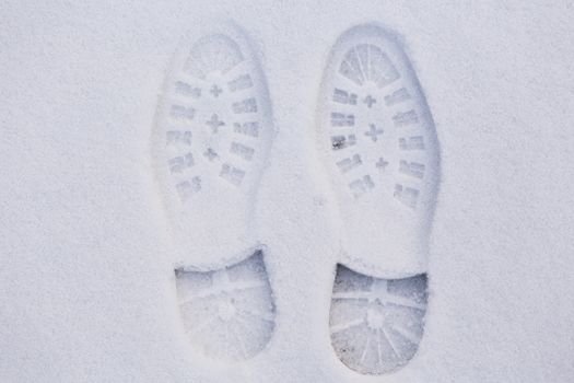 Picture of a pair of footprints in white snow