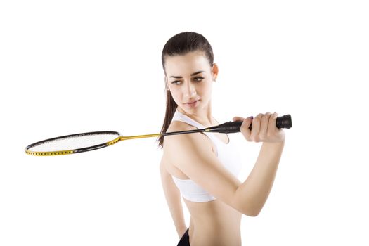 Beautiful girl holding badminton racket isolated on white background. Active healthy lifestyle.