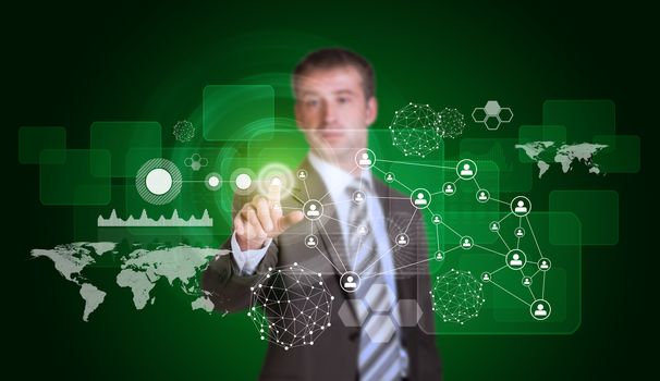 Businessman in suit finger presses virtual button. Hexagons, graphs and world map