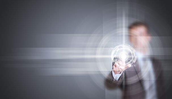 Businessman in suit finger presses virtual button. Gray gradient background