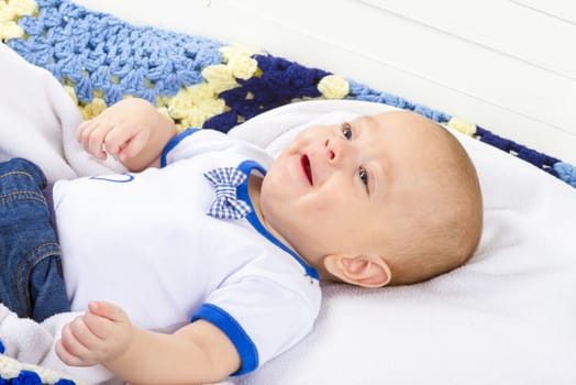 baby boy laughing on blanket