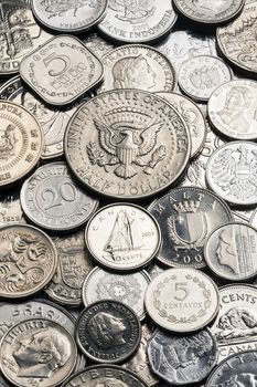 A collection of old silver coins from around the world