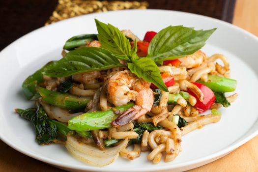 Thai food shrimp stir fry with lo mein noodles Shallow depth of field.