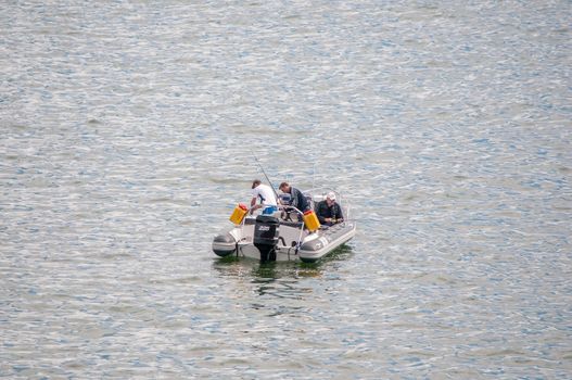 CAPE TOWN, SOUTH AFRICA - DECEMBER 20TH, 2014: A boat with unidentified anglers in the sea at Gordons Bay near Cape Town. It is a favorite fishing area for tourists
