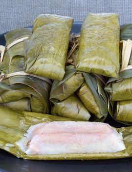 Glutinous rice with banana and peanut steamed in banana leaf - Thai traditional food