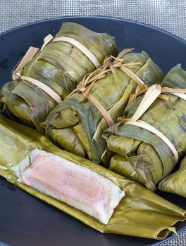 Glutinous rice with banana and peanut steamed in banana leaf - Thai traditional food